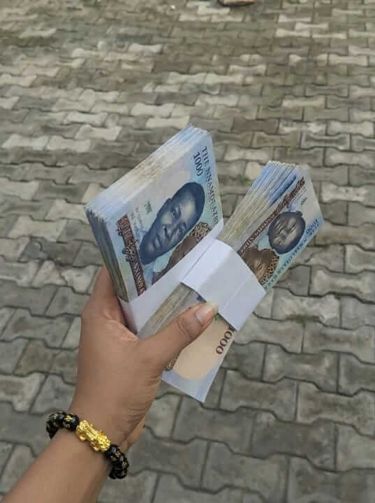 Customer holding cash wearing Pixiu